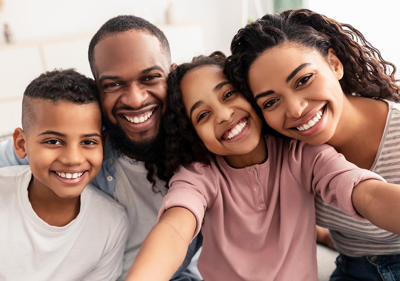 Close up selfie of a family smiling for the camera